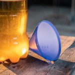 Hand,Is,Pouring,The,Used,Oil,Into,A,Clear,Bottle.