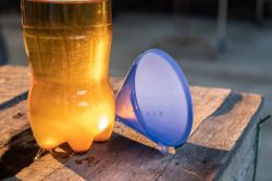 Hand,Is,Pouring,The,Used,Oil,Into,A,Clear,Bottle.