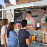 Smiling,Waiter,Taking,Order,From,Customer,At,Counter